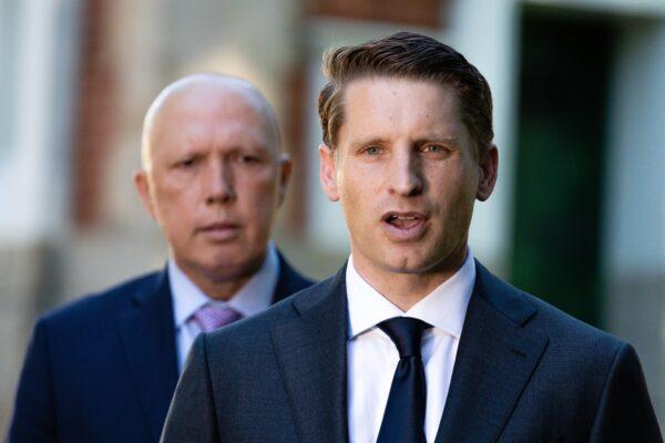 Assistant Defence Minister Andrew Hastie addresses media as Defence Minister Peter Dutton looks on in front of the Subiaco War Memorial in Perth, Australia, on April 19, 2021. (AAP Image/Richard Wainwright)