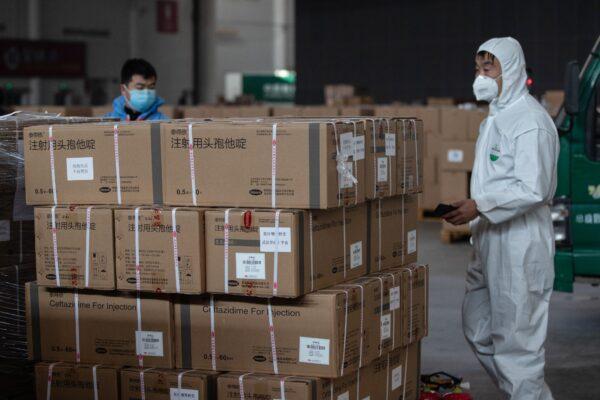 Staff members and volunteers transfer medical supplies at a warehouse in Wuhan on Feb. 4, 2020. (STR/AFP via Getty Images)
