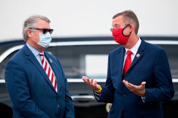 U.S. Reps. Rick Allen (L) (R-Ga.) and Doug Collins (R) (R-Ga.), speak as they await the arrival of President Donald Trump in Atlanta, Georgia, on July 15, 2020. (Jim Watson/AFP via Getty Images)