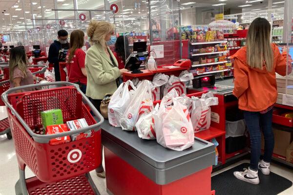 A customer wears a mask as she waits to get a receipt at a register in a Target store in Vernon Hills, Ill., on May 23, 2021. (Nam Y. Huh/AP Photo)