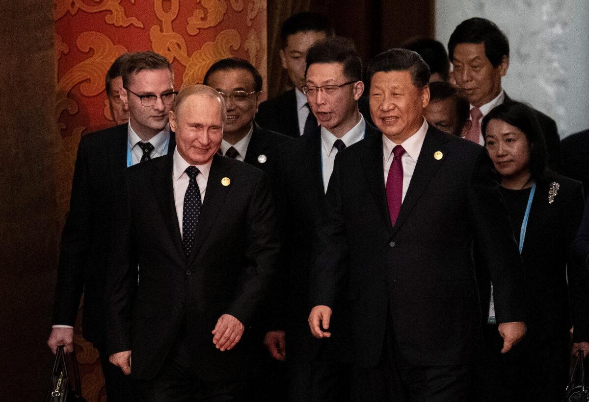 Russia's President Vladimir Putin (front L) and Chinese leader Xi Jinping (C) arrive for the welcome banquet for leaders attending the Belt and Road Forum at the Great Hall of the People in Beijing, China, on April 26, 2019. (Nicolas Asfouri/Pool/Getty Images)