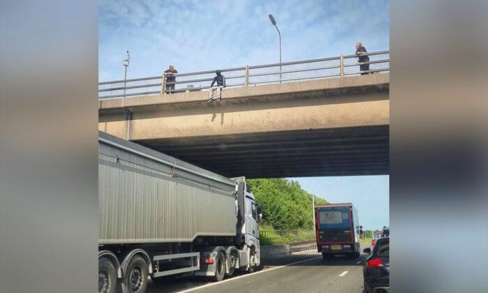 Man Seen Dangling Off UK Motorway Bridge—Then Truck Driver Parks Under Him to Save His Life