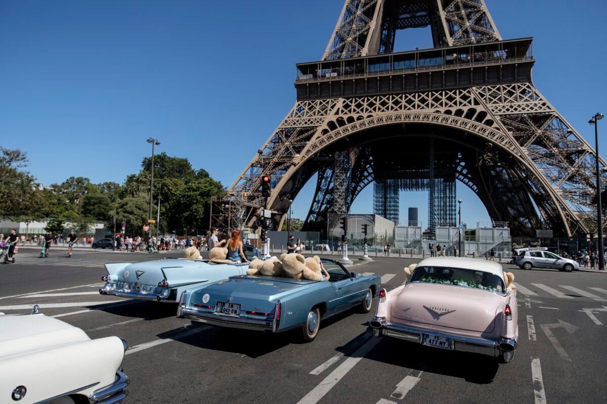 Teddy bears, set up by Philippe Labourel, who wants to be named 'Le papa des nounours' (Teddy Bears father) are pictured inside American vintage cars driving through Paris, on June, 13, 2021. (Lewis Joly/AP Photo)