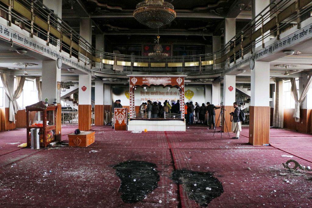 Security personnel inspect a damaged Sikh-Hindu Temple alongside media representatives following a gun attack in Kabul on March 25, 2020.  (STR/AFP via Getty Images)