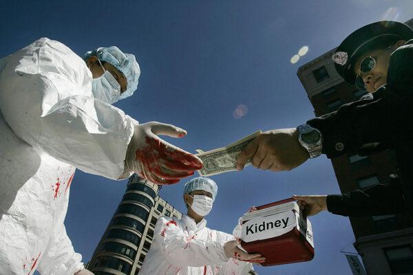 Falun Gong demonstrators dramatize an illegal act of paying for human organs during a protest in Washington on April 19, 2006. (Jim Watson/AFP via Getty Images)