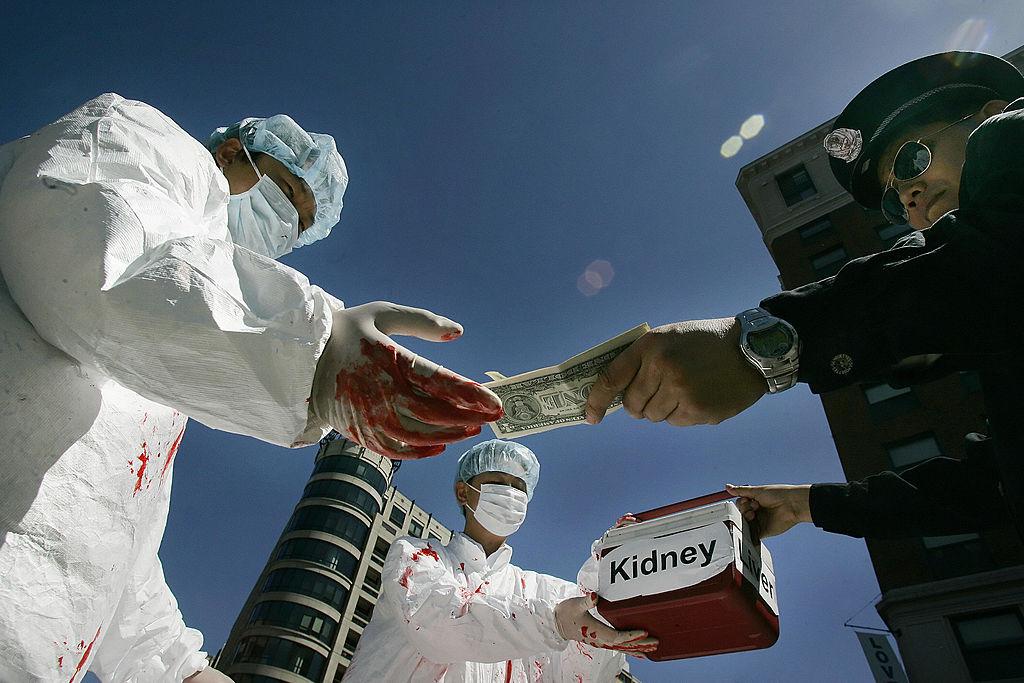 Falun Gong demonstrators dramatize an illegal act of paying for human organs during a protest in Washington, in conjunction with a visit by Chinese leader Hu Jintao to the United States, on April 19, 2006. (JIM WATSON/AFP via Getty Images)