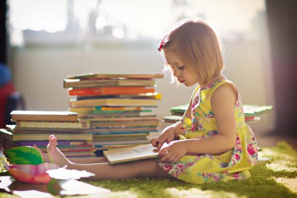 Some of kids' best summer memories are of long, lazy days with a stack of books. (Tatiana Bobkova/Shutterstock)
