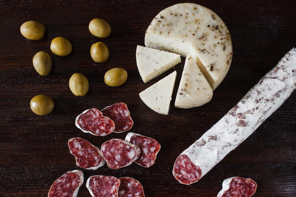 Start with drinks and an array of tapas: cured olives, slices of salami and chorizo, freshly made bread and chunks of cheese, rosemary-infused almonds. (Pavel Korotkov/Shutterstock)