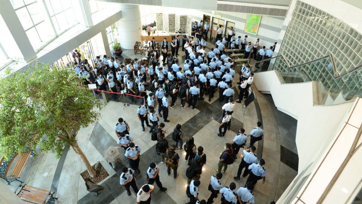 In this handout image provided by Apple Daily, police officers conduct a raid at the Apple Daily office in Hong Kong on June 17, 2021. (Apple Daily via Getty Images)