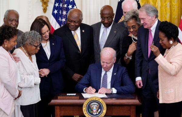 President Joe Biden signs the Juneteenth National Independence Day Act, in the East Room of the White House in Washington on June 17, 2021. (Evan Vucci/AP Photo)