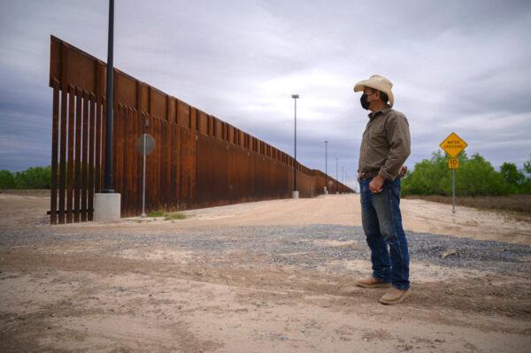 A ranch owner stands before a portion of the unfinished border wall that former U.S. president Donald Trump tried to build, near Roma, Texas, on March 28, 2021. (Ed Jones/AFP via Getty Images)