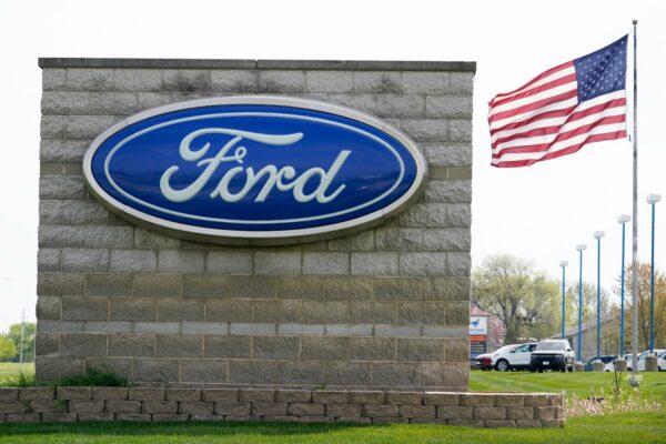An American flag flies over a Ford auto dealership, in Waukee, Iowa, on April 27, 2021. (Charlie Neibergall/AP Photo)