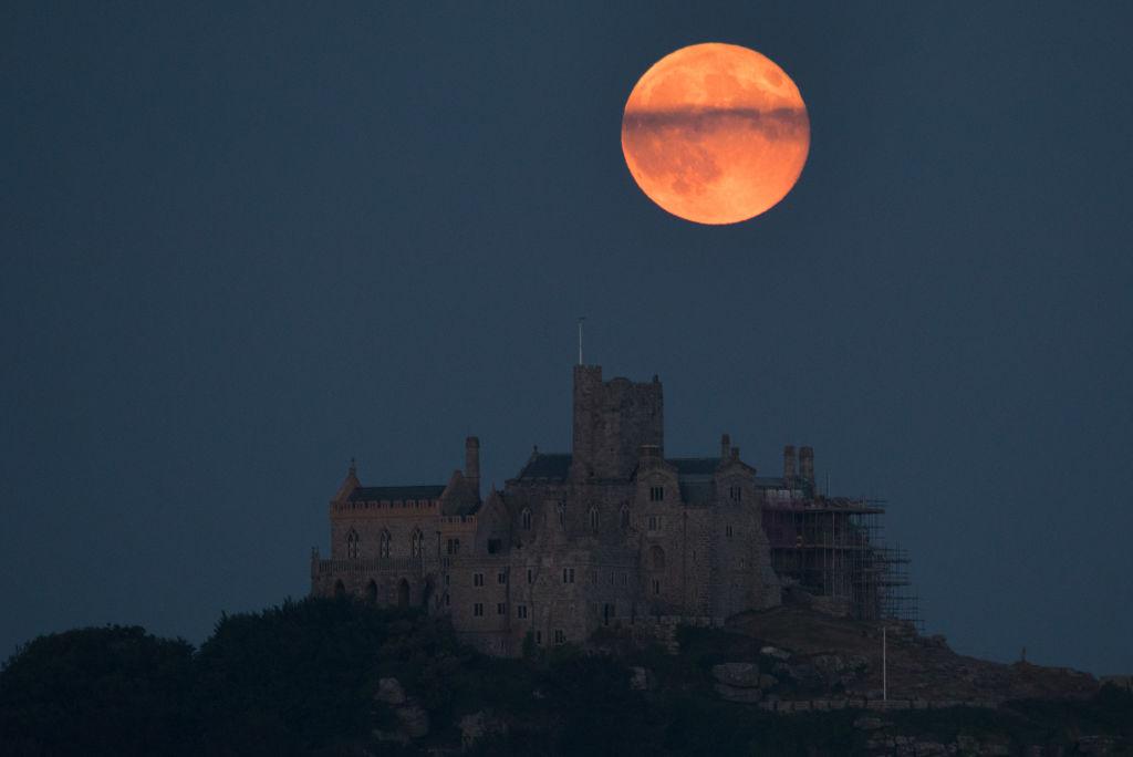 The Strawberry Moon rising behind St. Michael's Mount in Marazion near Penzance in Cornwall, England, on June 28, 2018. (Matt Cardy/Getty Images)