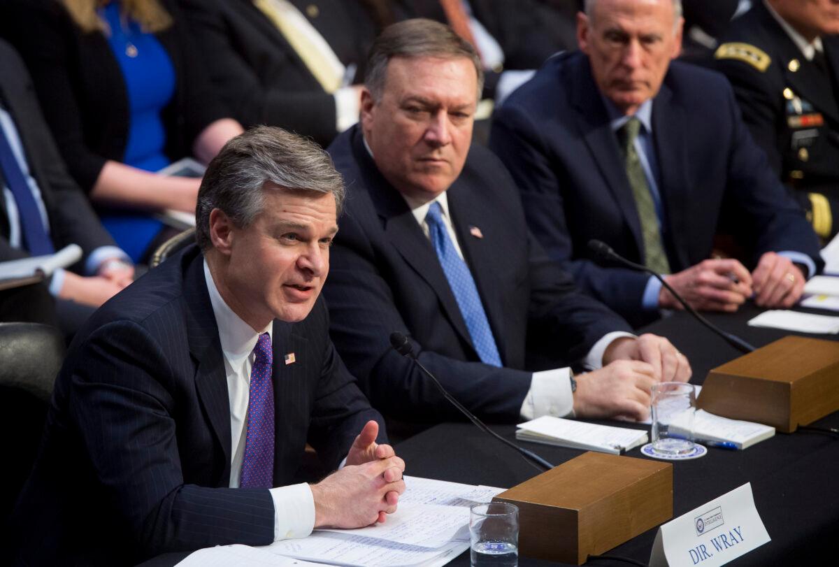 FBI Director Christopher Wray (L), then-CIA Director Mike Pompeo (C), and then-Director of National Intelligence Dan Coats (R) testify on worldwide threats during a Senate Intelligence Committee hearing on Capitol Hill in Washington on Feb. 13, 2018. (Saul Loeb/AFP via Getty Images)
