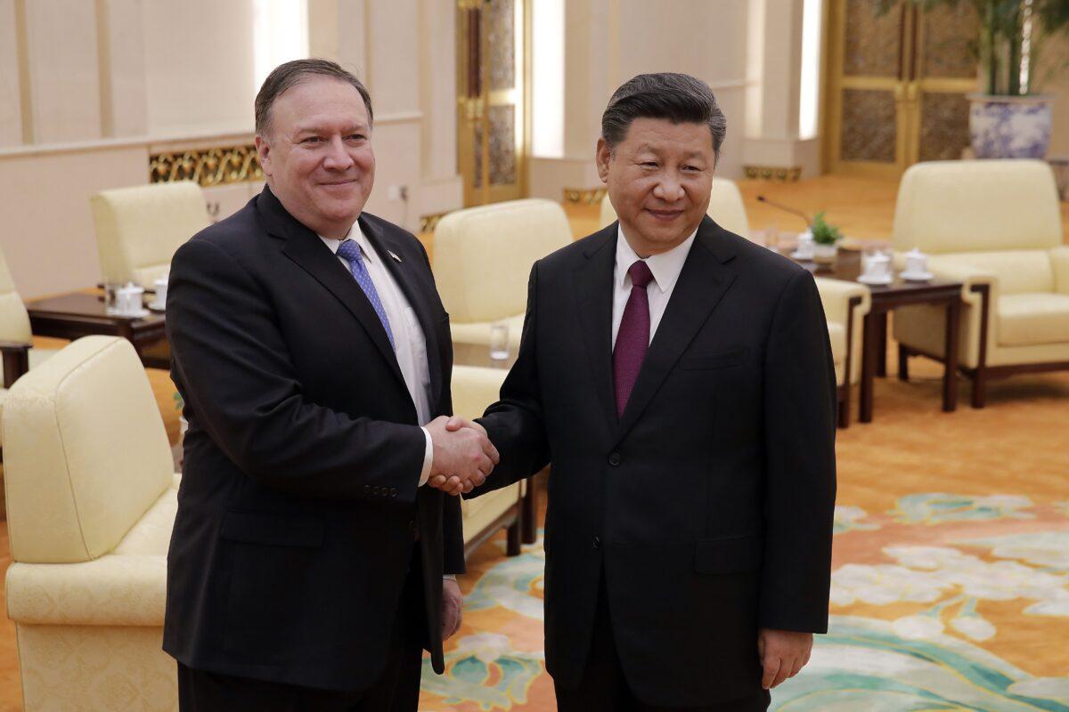 Then-Secretary of State Mike Pompeo (L) shakes hands with Chinese leader Xi Jinping as they pose for photographs at the Great Hall of the People in Beijing on June 14, 2018. (Andy Wong/AFP via Getty Images)