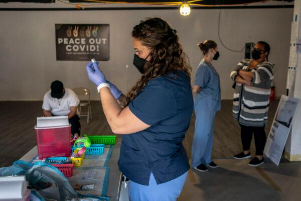 Nurse practitioner Nicole Warner prepares doses of COVID-19 vaccines during the Joints4Jabs COVID-19 vaccination clinic at the Uncle Ikes White Center cannabis shop in Seattle, Wash., on June 16, 2021. (David Ryder/Getty Images)