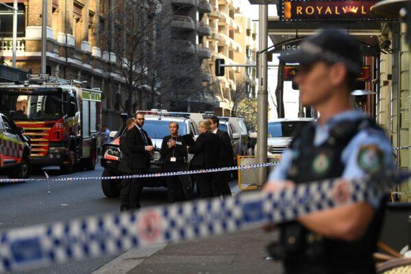 Police gather at the crime scene in central Sydney, Australia, on Aug. 13, 2019. (Photo by Saeed KHAN / AFP via Getty Images)