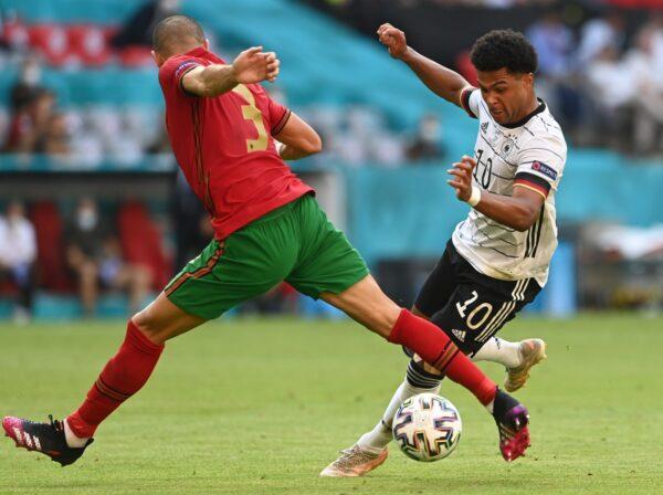 Portugal's Pepe (L) tries to tackle Germany's Serge Gnabry during the Euro 2020 soccer championship group F match between Portugal and Germany at the football arena stadium in Munich, Germany, on June 19, 2021. (Christof Stache/Pool via AP)