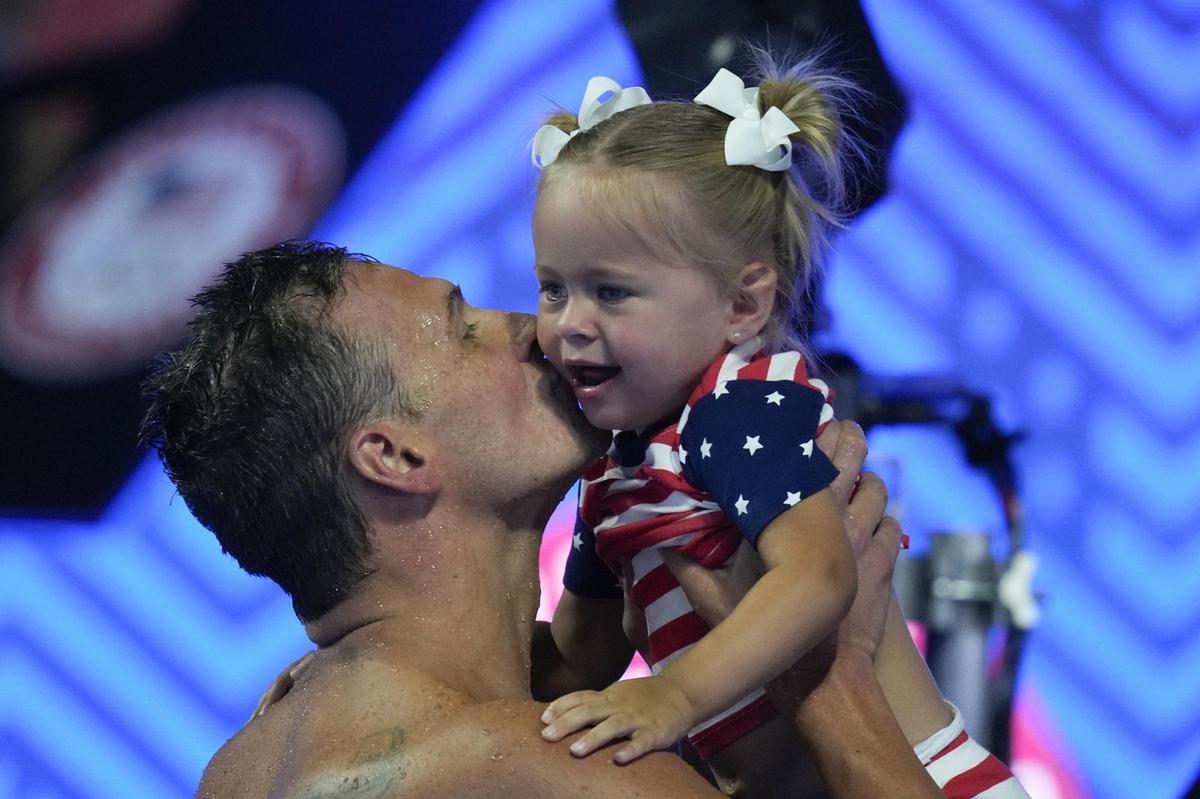 Ryan Lochte kisses his daughter after his heat in the men's 200 Individual Medley during wave 2 of the U.S. Olympic Swim Trials in Omaha, Neb., on June 17, 2021. (Charlie Neibergall/AP Photo)
