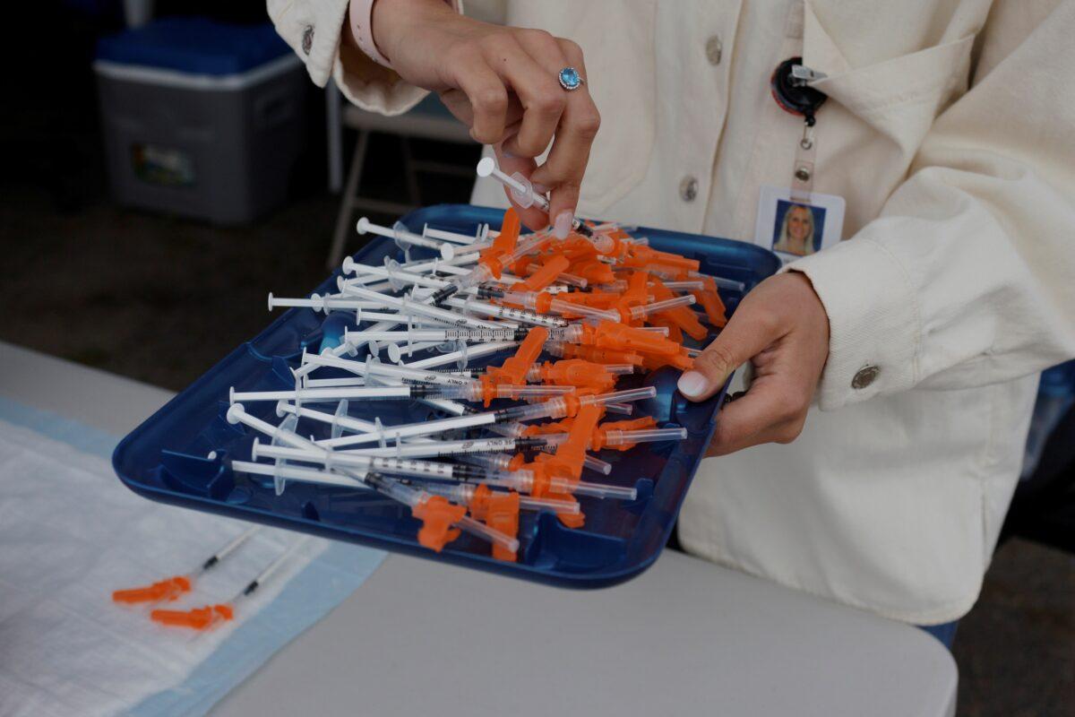 A doctor puts out syringes with the Pfizer COVID-19 vaccine at a clinic at La Colaborativa in Chelsea, Mass., on June 11, 2021. (Brian Snyder/Reuters)