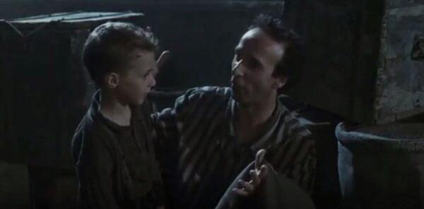 Giosué (Giorgio Cantarini, L) and his father, Guido (Roberto Benigni), in a Nazi death camp. (Miramax Films)