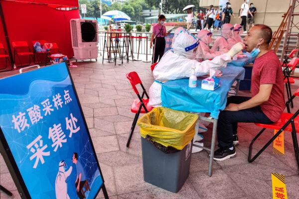 People take a COVID-19 test in Shenzhen, in China's southern Guangdong Province, on June 6, 2021. (STR/AFP via Getty Images)