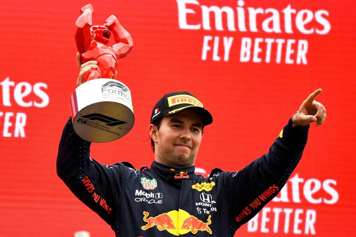 Red Bull driver Sergio Perez of Mexico celebrates from the podium his third place after the French Formula One Grand Prix at the Paul Ricard racetrack in Le Castellet, southern France, on June 20, 2021. (Nicolas Tucat/Pool via AP)
