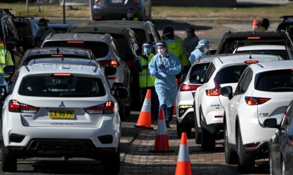 Health staff register residents at a COVID-19 drive-through testing site on Bondi Beach in Sydney after the reports of four new positive cases on June 17, 2021. (Saeed Khan/AFP via Getty Images)