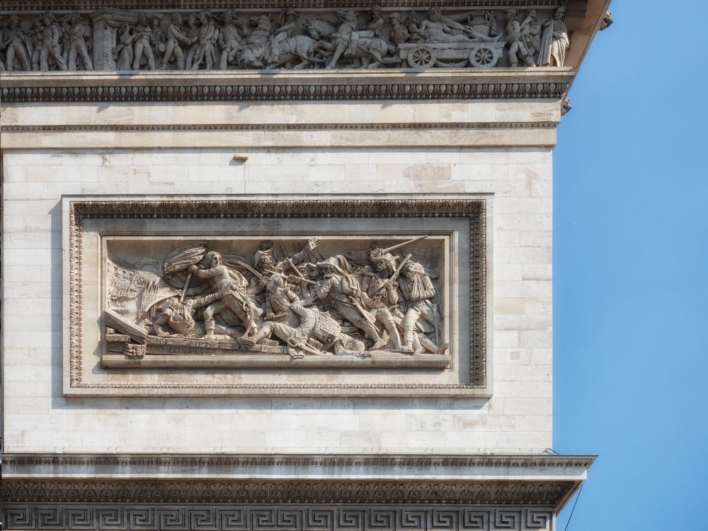 A furious battle scene plays out on a bas-relief near the top of the arch. And on the frieze that runs around the top of the arch, French troops can be seen both leaving for and returning from battle. (Chris Lawrence Travel/Shutterstock)