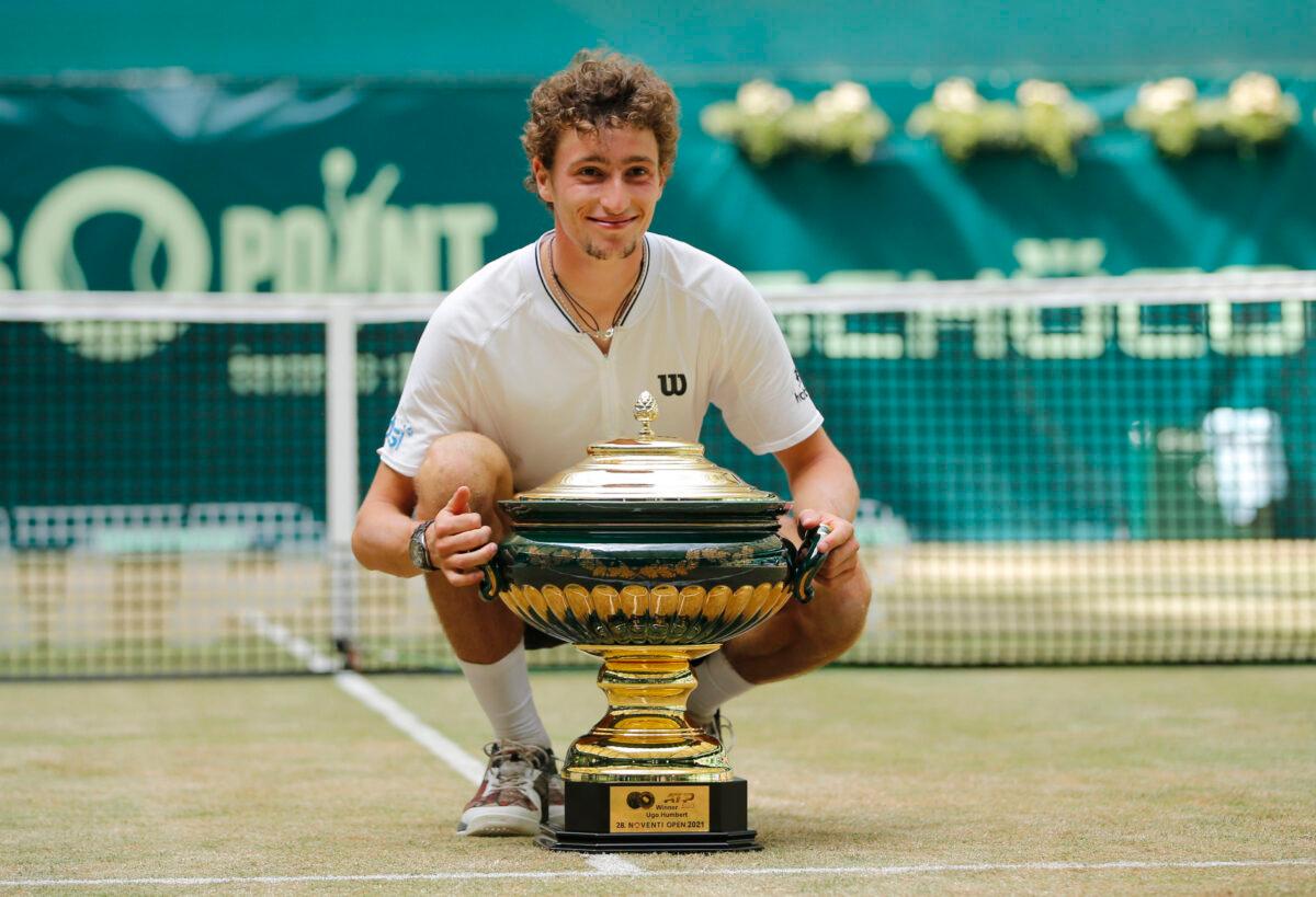 France's Ugo Humbert poses with a trophy as he celebrates after winning the final against Russia's Andrey Rublev, at the ATP 500 Halle Open tennis tournament at the Gerry Weber Stadion, in Halle, Germany, on June 20, 2021. (Leon Kuegeler/Reuters)