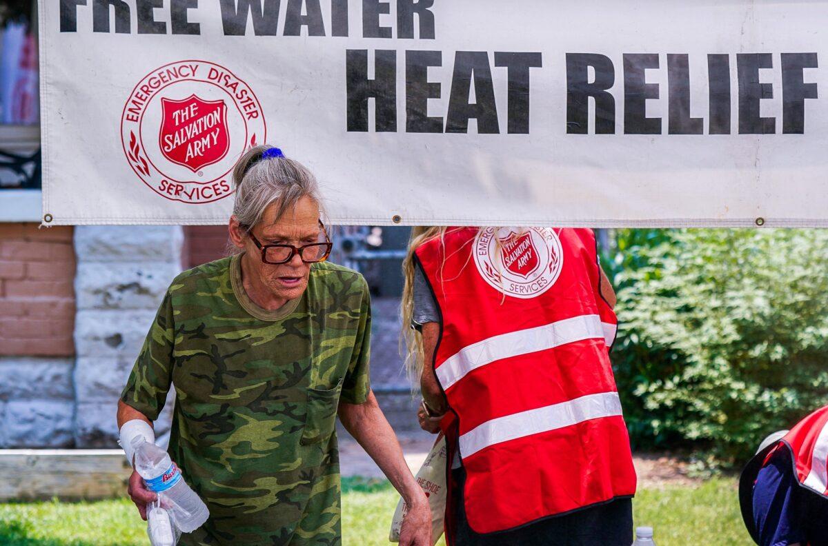 A woman holds a bottle of cold water at a Salvation Army hydration station during a heatwave as temperatures hit 115 degrees in Phoenix on June 15, 2021. (Ross D. Franklin/File/AP Photo)