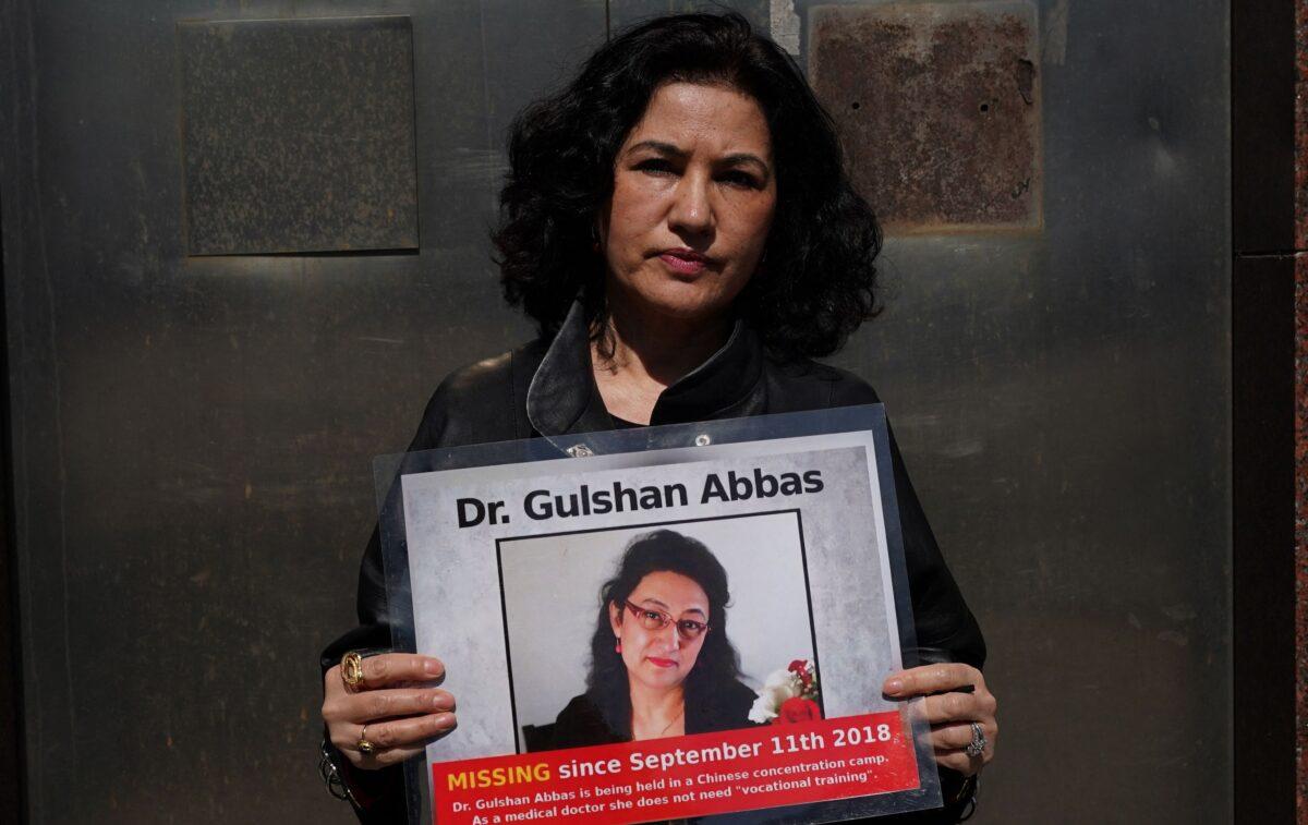 Rushan Abbas, executive director of Campaign for Uyghurs, holds a photo of her sister, Gulshan Abbas, who is currently imprisoned in a Chinese camp, during a rally in New York on March 22, 2021. (Timothy Clary/AFP via Getty Images)
