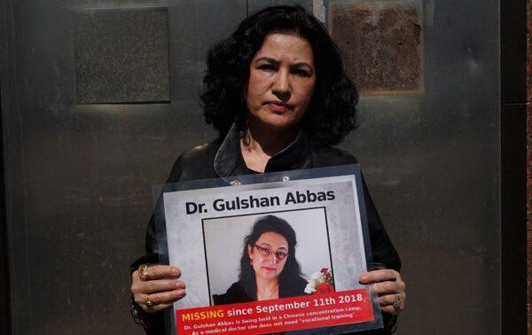 Rushan Abbas holds a photo of her sister, Gulshan Abbas, who is currently imprisoned in a Chinese camp, during a rally in New York on March 22, 2021. (Timothy Clary/AFP via Getty Images)