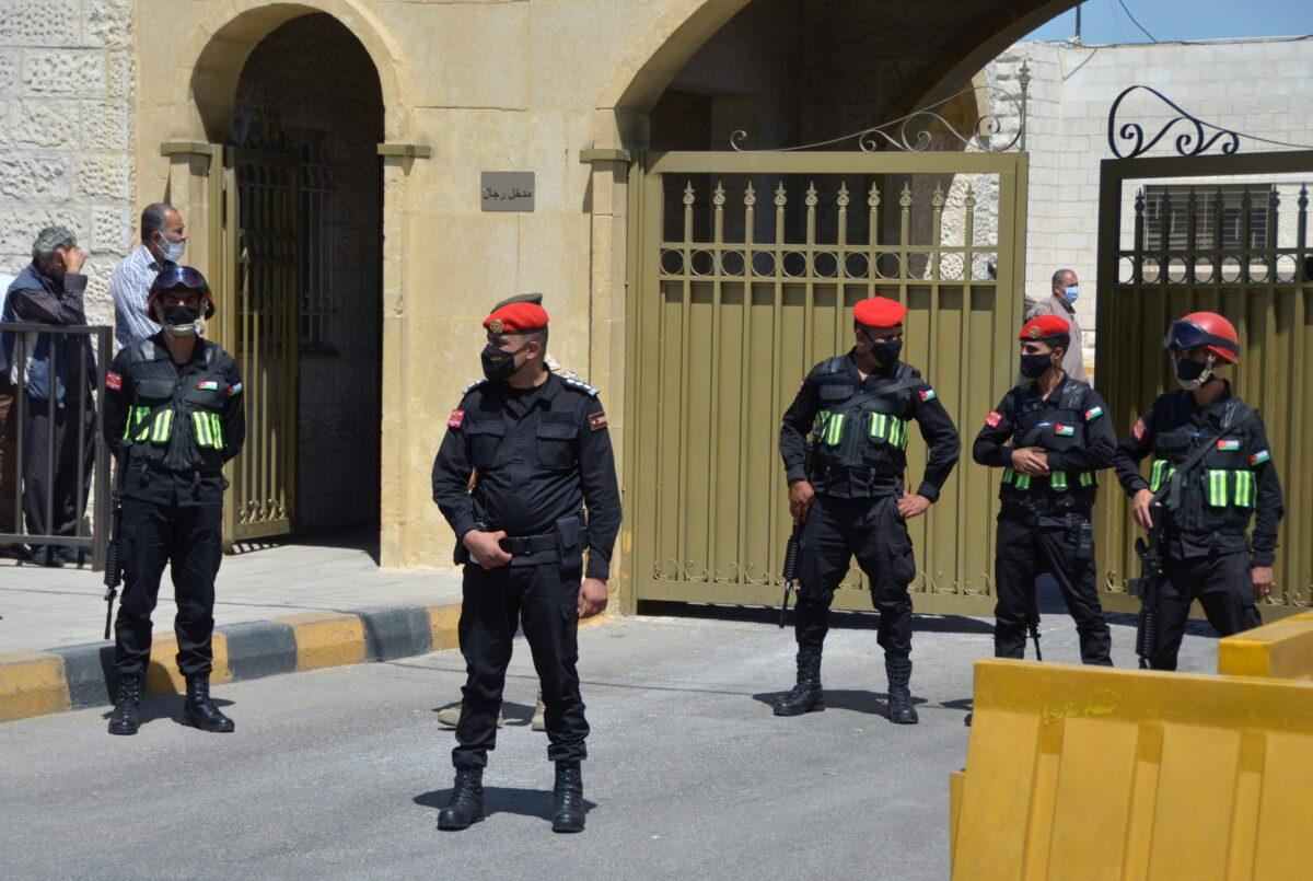 Security members stand guard outside a military court where the trial of former royal court chief Bassem Awadallah and a minor royal, Sherif Hassan Zaid, is set to take place in Amman, Jordan, on June 21, 2021. (Muath Freij/Reuters)