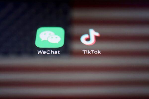A reflection of the U.S. flag is seen on the signs of the WeChat and TikTok apps on Sept. 19, 2020. (Florence Lo/Reuters)