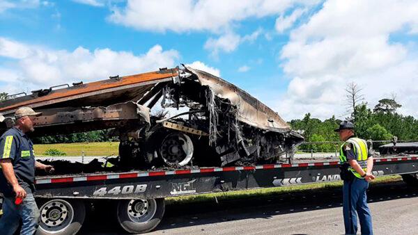 Some of the wreckage from a fatal multiple-vehicle crash a day earlier is loaded to be carried away, in Butler County, Ala., on June 20, 2021. (Lawrence Specker/Press-Register/AL.com via AP)