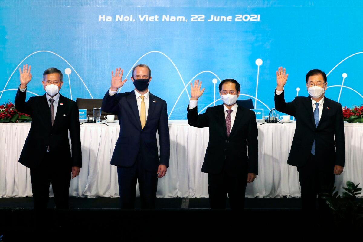 From left, Singaporean Foreign Minister Vivian Balakrishnan, Britain's Foreign Secretary Dominic Raab, Vietnamese Foreign Minister Bui Thanh Son, and South Korean Foreign Minister Chung Eui-yong stand for photos ahead of a meeting in Hanoi, Vietnam, on June 22, 2021. (Hau Dinh/AP Photo)