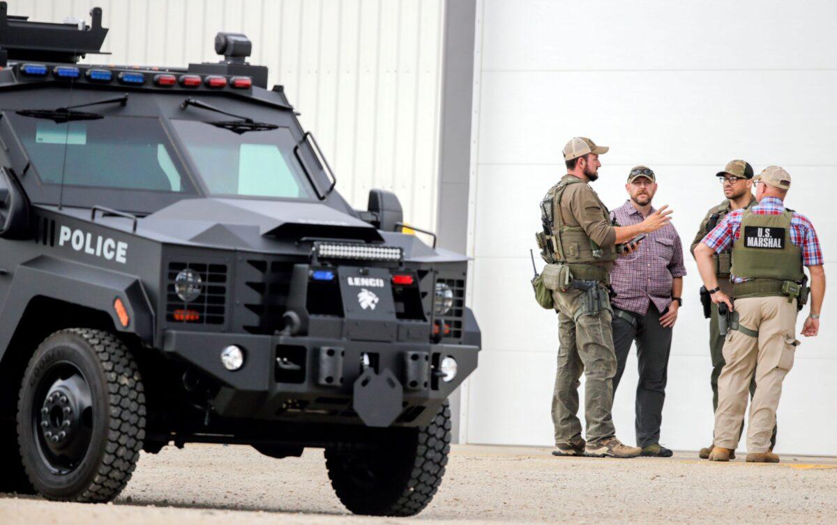 A tactical vehicle from the Cedar Rapids Police Department is seen as law enforcement stage as they search for a robbery and shooting suspect in Coggon, Iowa, on June 21, 2021. (Jim Slosiarek/The Gazette via AP)