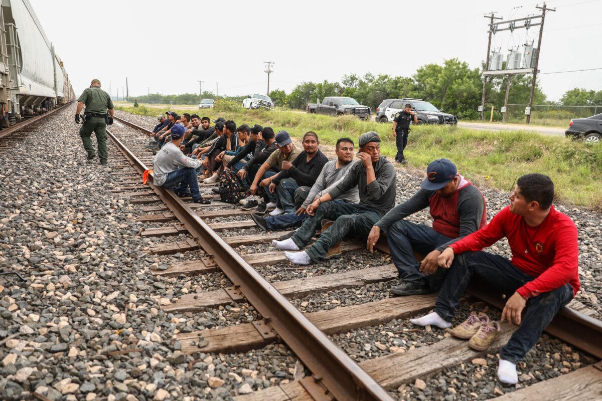 Border Patrol agents apprehend 21 illegal aliens from Mexico who had hidden in a grain hopper on a freight train heading to San Antonio, on June 21, 2021. (Charlotte Cuthbertson/The Epoch Times)