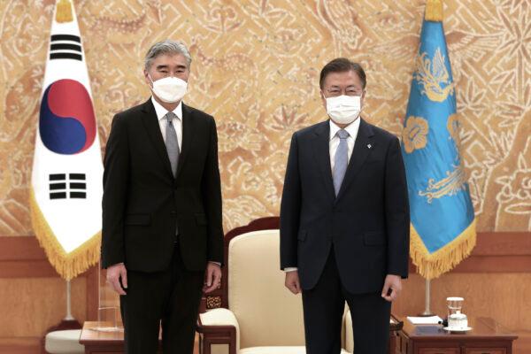 South Korean President Moon Jae-in, right, and U.S. Special Representative for North Korea, Sung Kim, pose for photos prior to their meeting at the presidential Blue House in Seoul, South Korea, Tuesday, June 22, 2021.(Choe Jae-koo/Yonhap via AP)