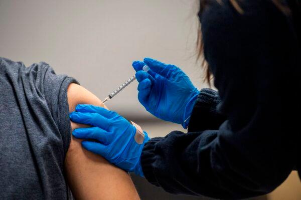 A person is inoculated with a vaccine in Chelsea, Massachusetts, on Feb. 16, 2021. (Joseph Prezioso/AFP via Getty Images)