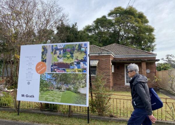 A man walks past a derelict home, which sold for $1.6 million (US$1.2 million), in Sydney's northwest in Australia, on June 23, 2021. (Swati Pandey/Reuters)