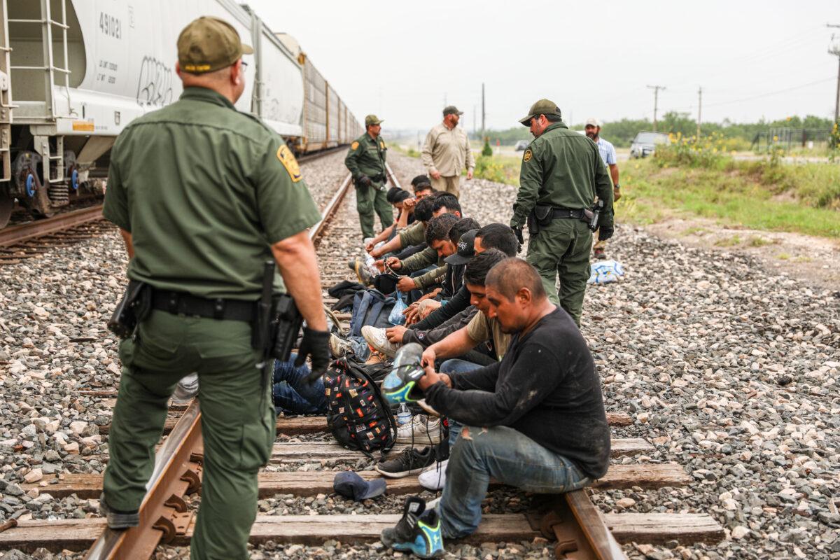 Border Patrol agents apprehend 21 illegal aliens from Mexico who had hidden in a grain hopper on a freight train heading to San Antonio, near Uvalde, Texas, on June 21, 2021. (Charlotte Cuthbertson/The Epoch Times)