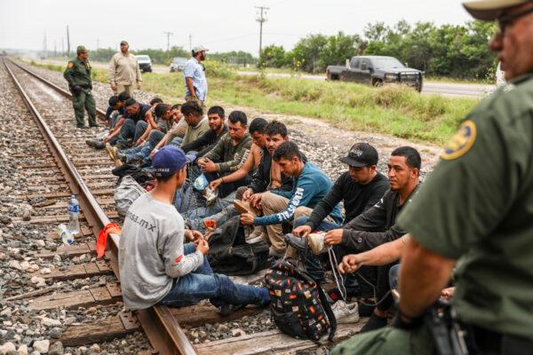 Border Patrol agents apprehend 21 illegal aliens from Mexico who had hidden in a grain hopper on a freight train heading to San Antonio, on June 21, 2021. (Charlotte Cuthbertson/The Epoch Times)
