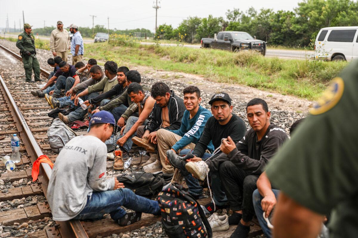Border Patrol agents apprehend 21 illegal aliens from Mexico who had hidden in a grain hopper on a freight train heading to San Antonio, near Uvalde, Texas, on June 21, 2021. (Charlotte Cuthbertson/The Epoch Times)