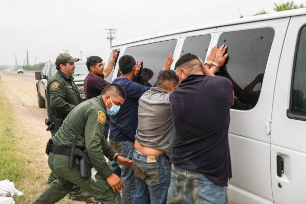 Border Patrol agents apprehend illegal aliens from Mexico who had hidden in a grain hopper on a freight train heading to San Antonio, on June 21, 2021. (Charlotte Cuthbertson/The Epoch Times)