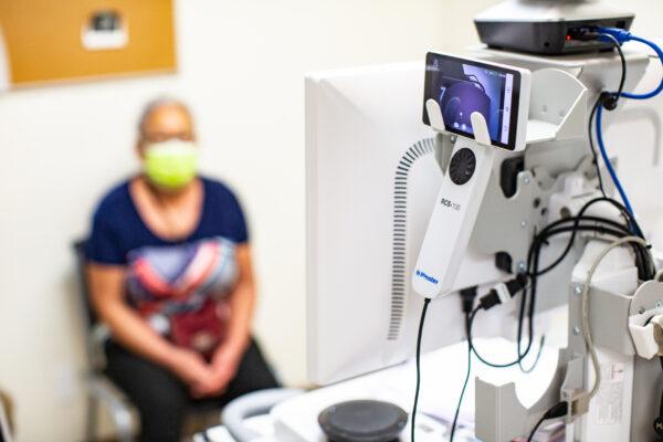 A patient at the Lestonnac Free Clinic talks with a doctor about her health issues using a telemedicine machine in Orange, Calif., on June 21, 2021. (John Fredricks/The Epoch Times)