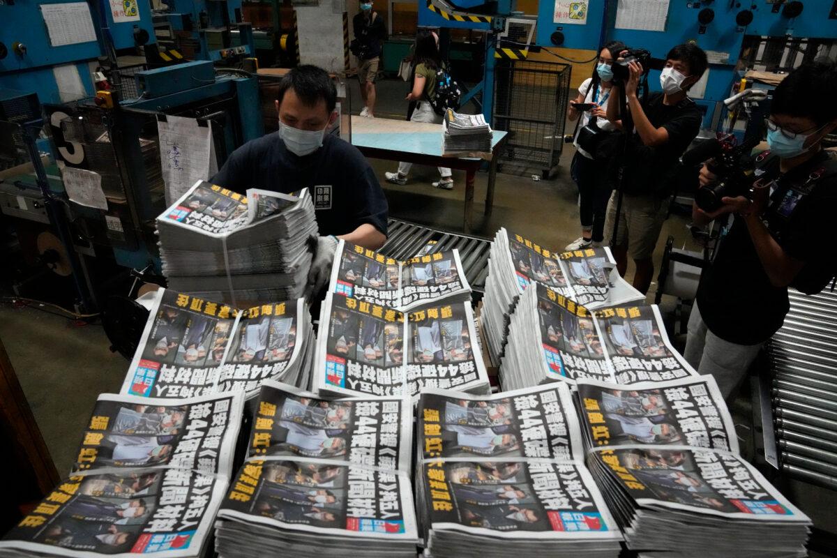 A worker packs copies of the Apple Daily newspaper at the printing house in Hong Kong, on June 18, 2021. (Kin Cheung/AP Photo)