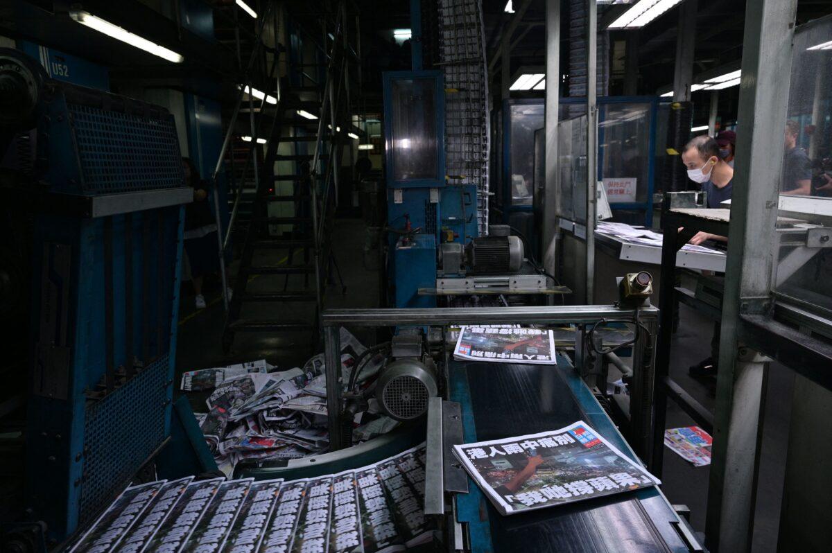 Apple Daily employees work in the printing room for the next day's paper, for what was announced the previous day to be for the last time, in Hong Kong, early on June 24, 2021. (Anthony Wallace/AFP via Getty Images)