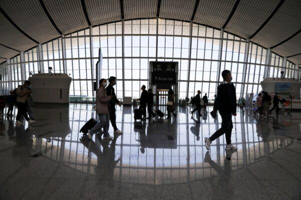 Travelers are seen at the Beijing Daxing International Airport on the first day of the Labor Day holiday in Beijing, on May 1, 2021. (Tingshu Wang/File Photo/Reuters)